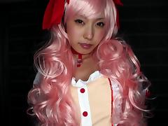 Asian bitch wearing a pink wig and sucking off two guys