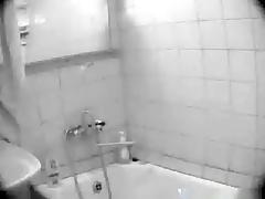 Voyeur tapes a big boobed girl taking a shower