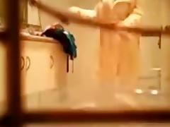 Voyeur tapes a brunette taking care of her naked body in the bathroom