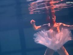 Sensual Russian redhead removes her clothes under the water