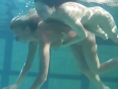 Two sexy lassie fool around in the nude while being submerged in water
