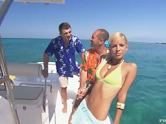 Naughty blond angel is getting two hard cocks on the yacht